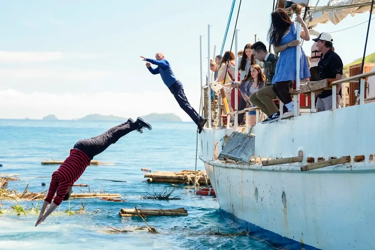 Survivor 51 castaways diving off the side of the boat into the sea on Day 1