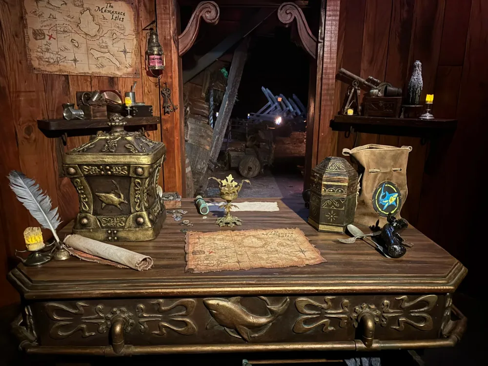 The empty Survivor 49 voting booth, with the urn, parchment and pen on the table