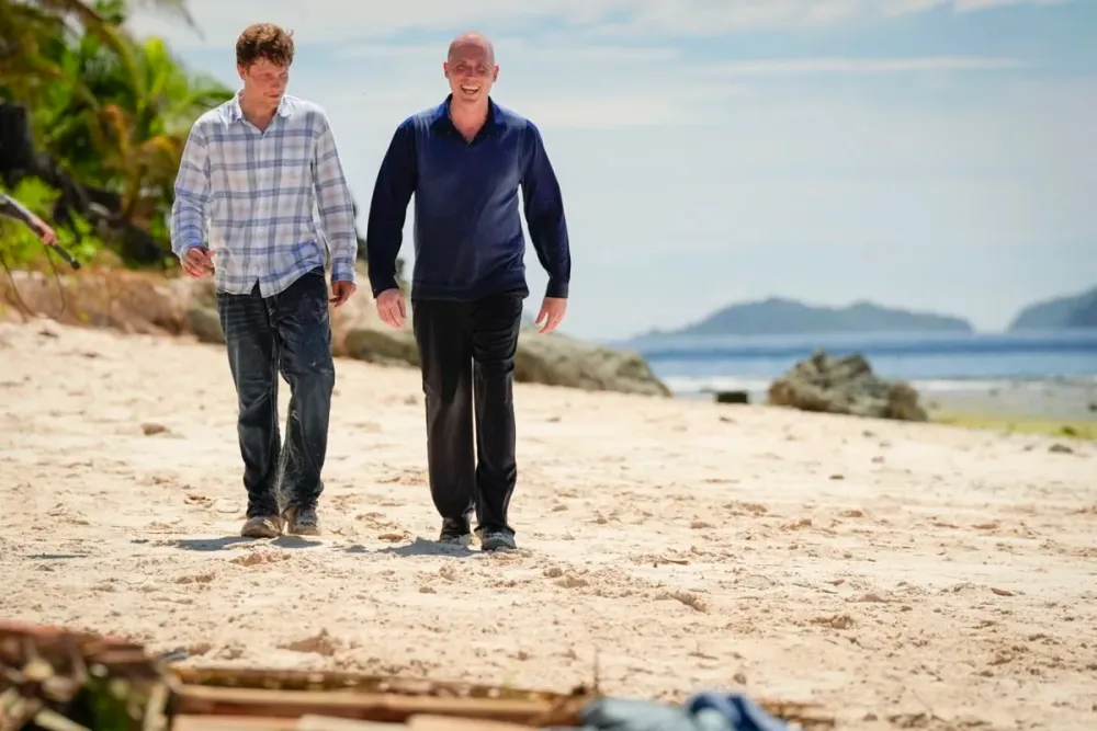 Carter Krull and Rob Antonson walking together on the beach in Survivor 51