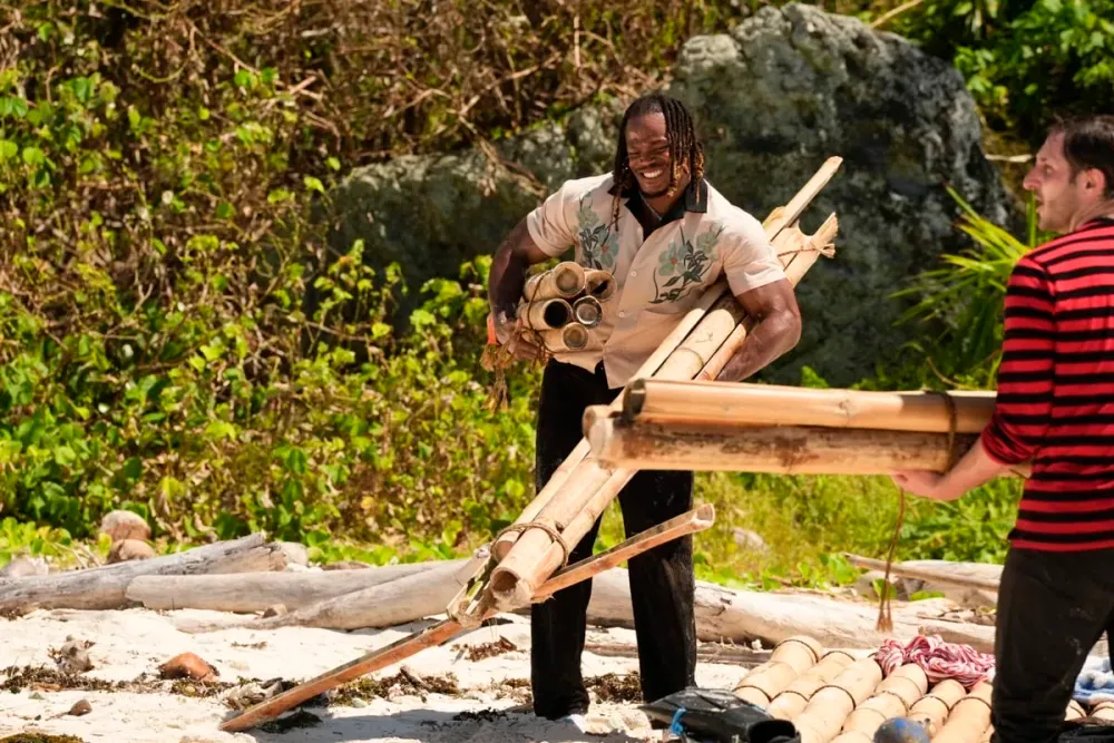 Ori Jean-Charles carrying bamboo on the beach on Day 1 of Survivor 51