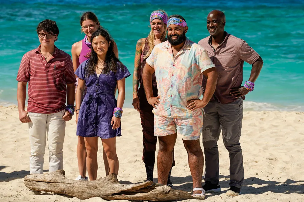 The Tika tribe of Survivor 44 posing on the beach in purple