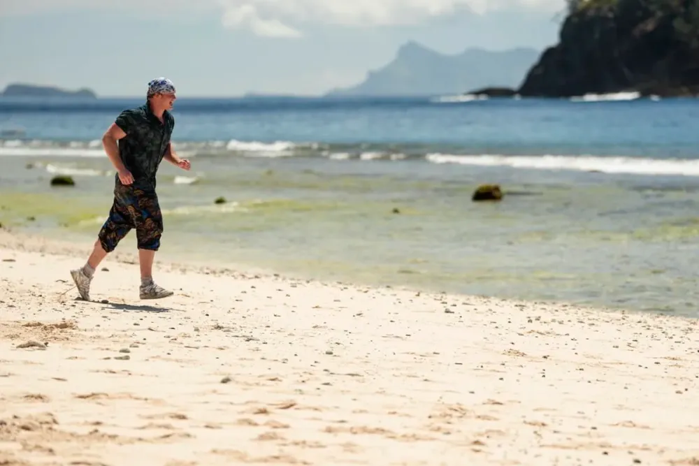 Brady Booker running along the beach on Day 1 of Survivor 51