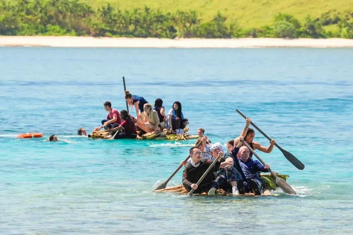Survivor 51 castaways paddling bamboo rafts to shore on Day 1