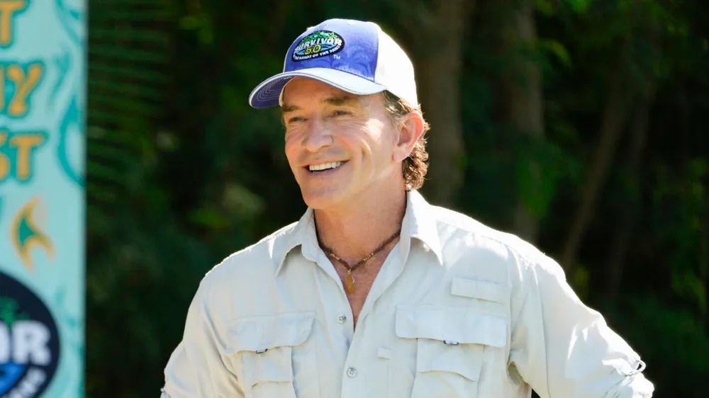 Jeff Probst smiling in a Survivor cap during Survivor 50